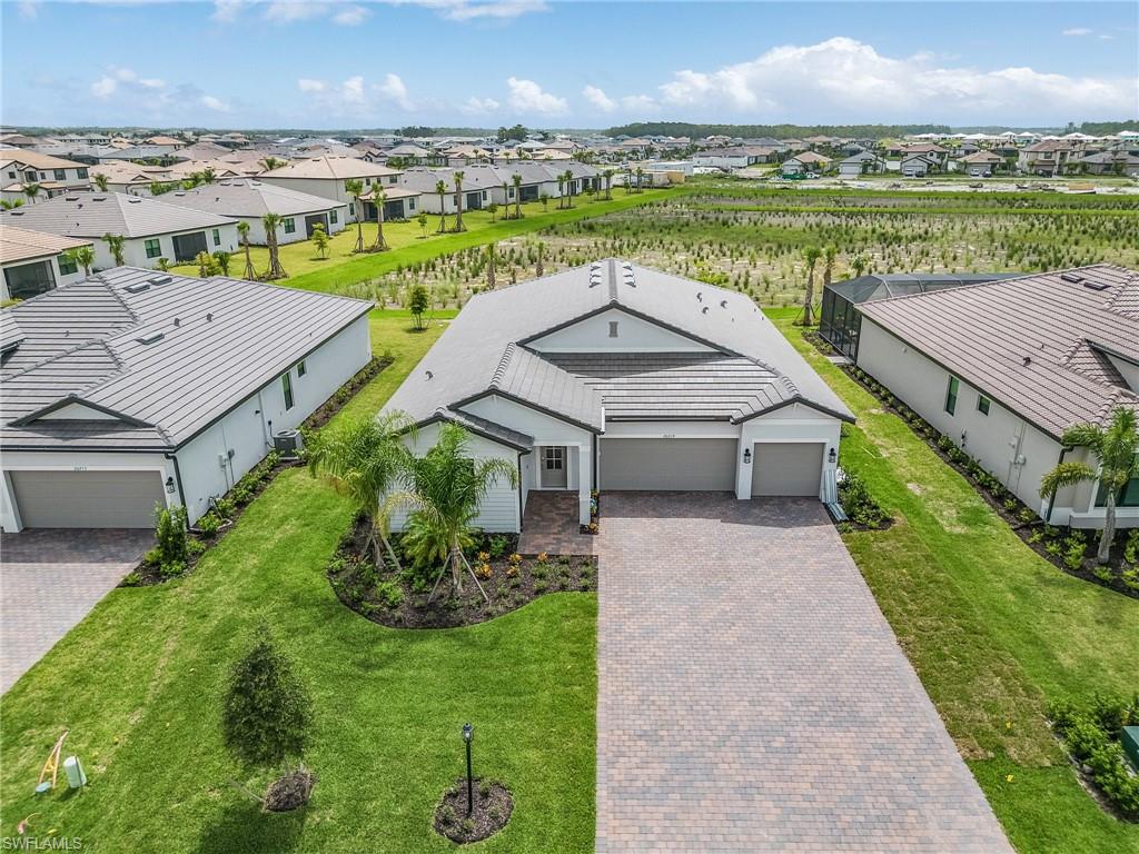 an aerial view of a house with a yard and lake view