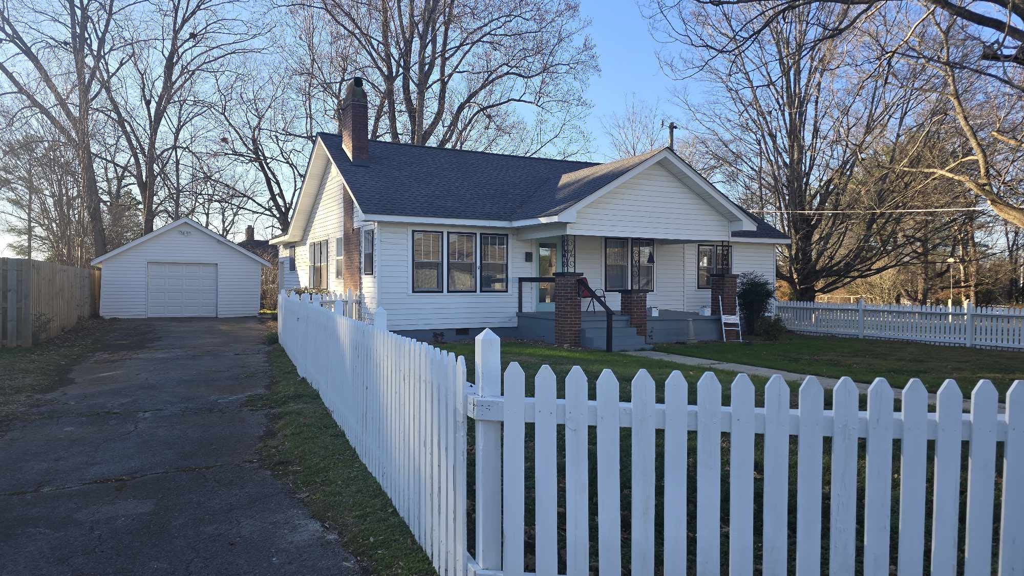 a front view of house with deck and yard