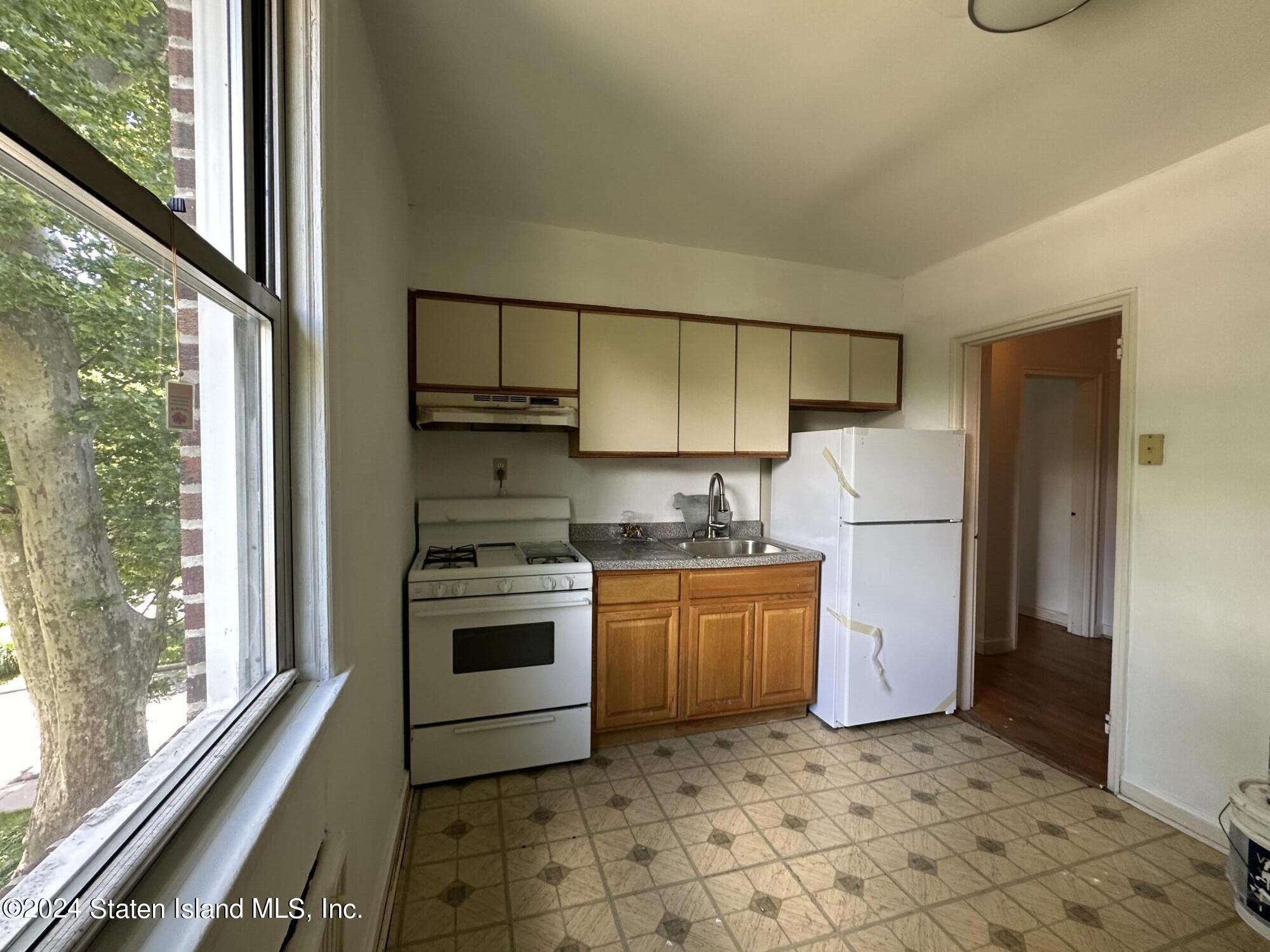 a kitchen with a refrigerator sink and stove