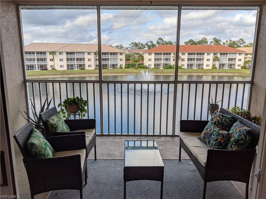 Unfurnished sunroom with a water view and ceiling fan