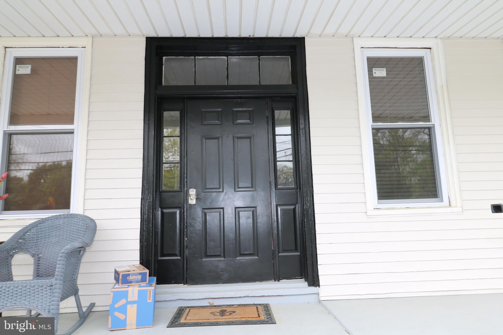 a front view of a house with a door and wooden door