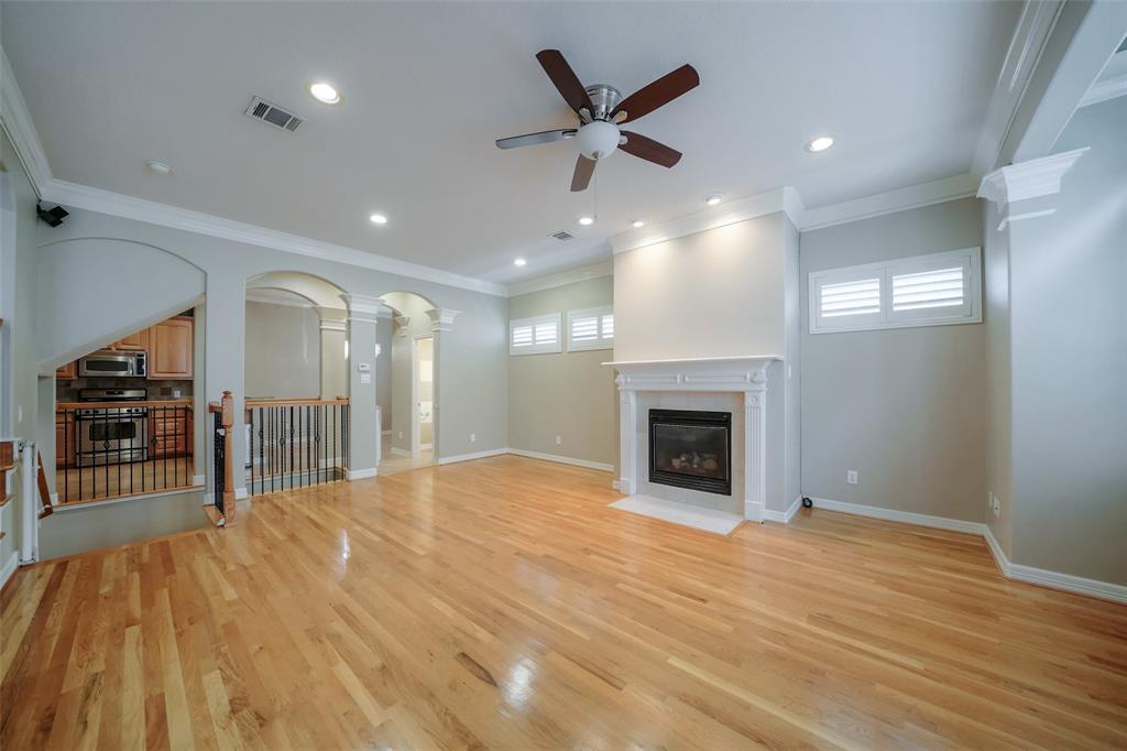 The living room with lots of light and gleaming hardwoods.