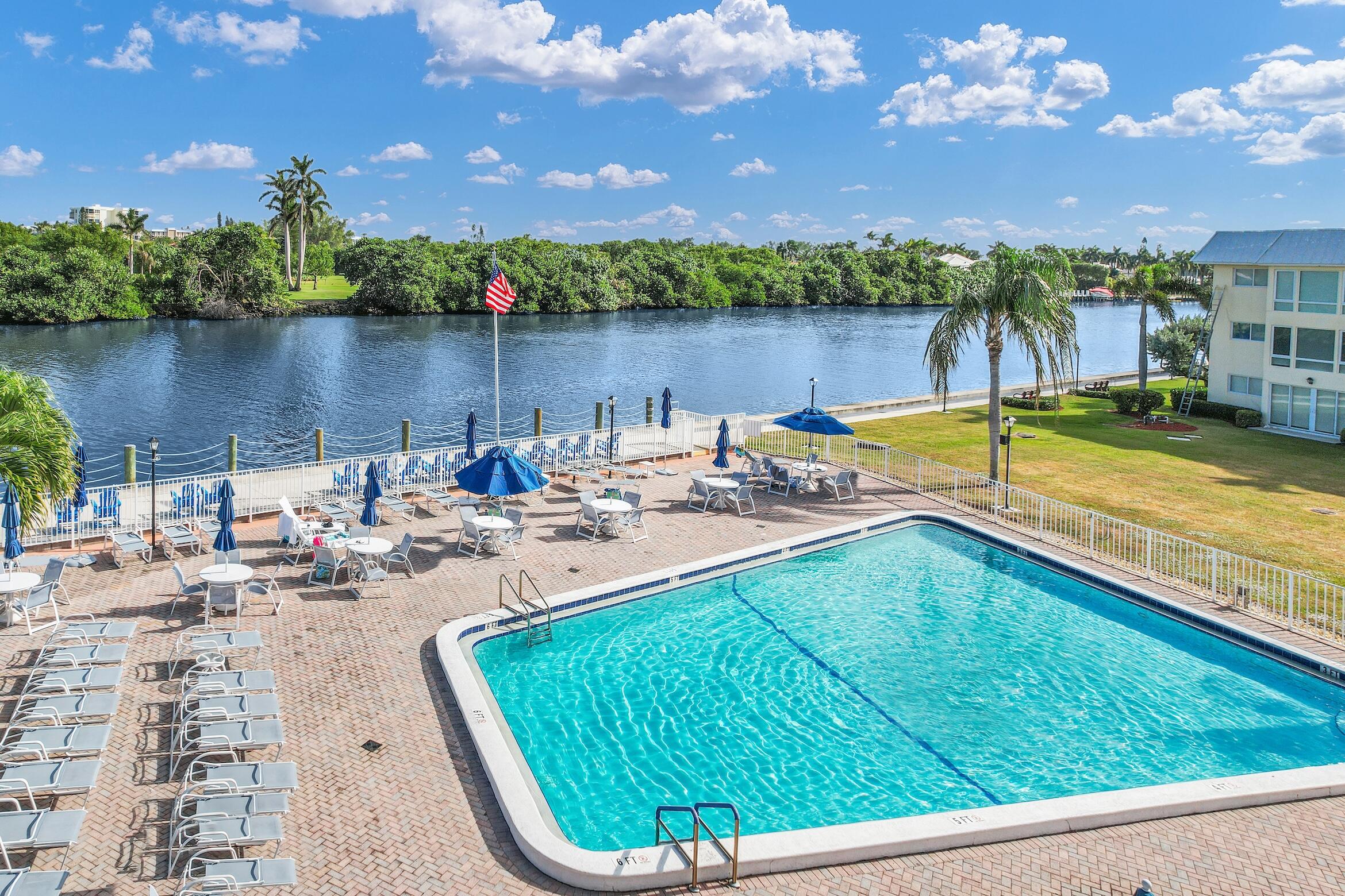 a view of a swimming pool and lounge chairs