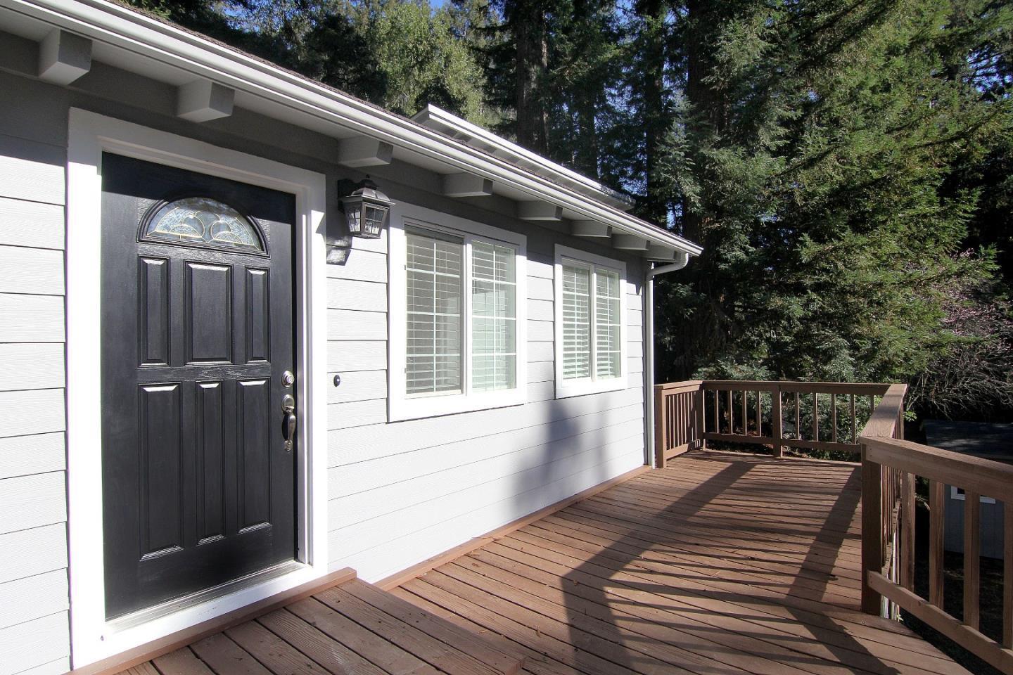 a view of deck with a chair and floor to ceiling window