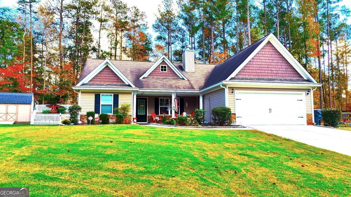 a front view of a house with a yard and trees