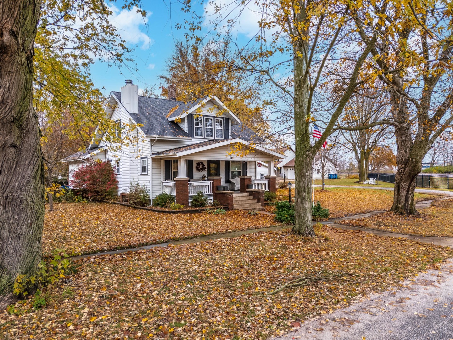 a front view of a house with yard and trees