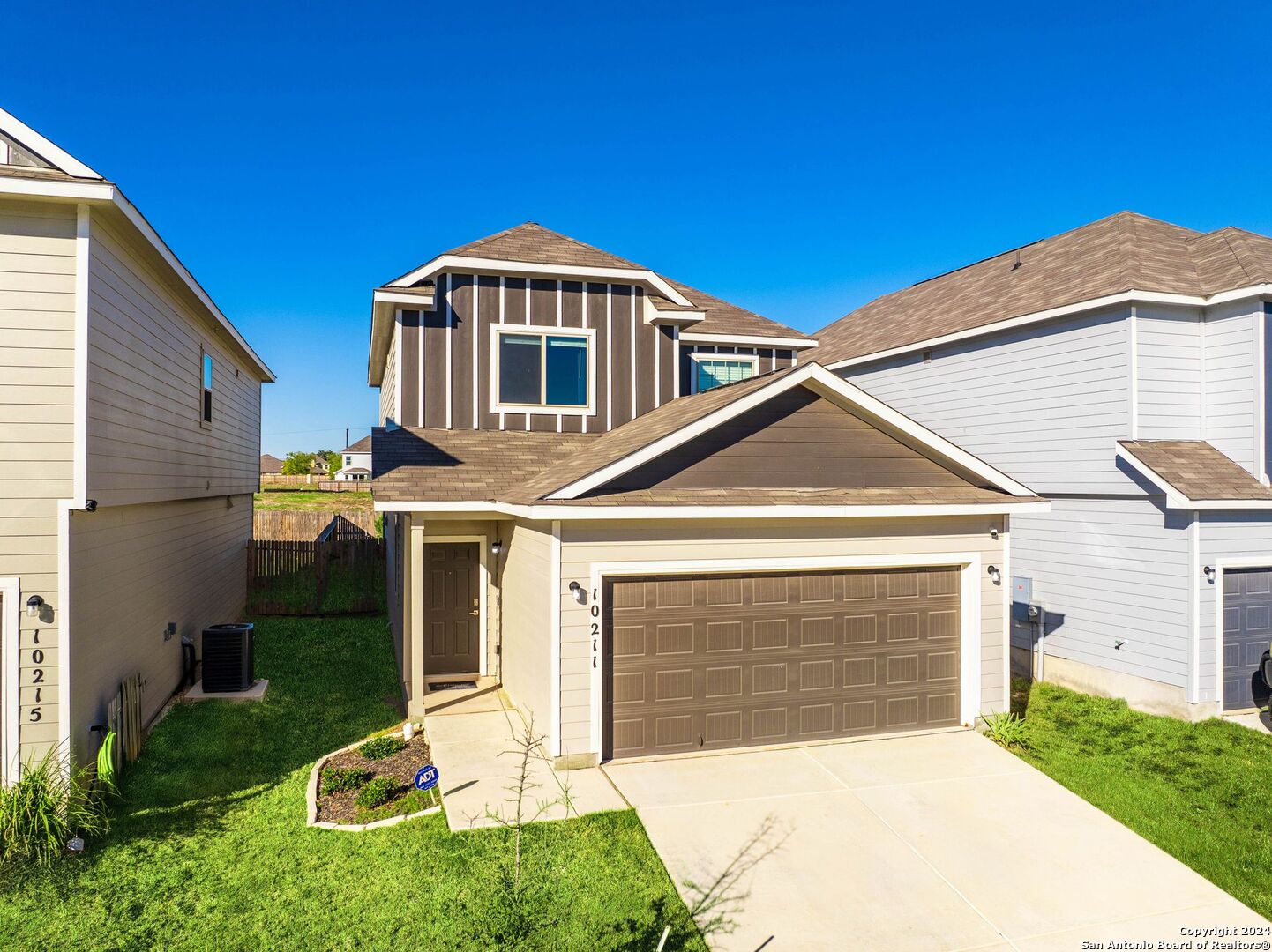 a front view of a house with a yard and garage