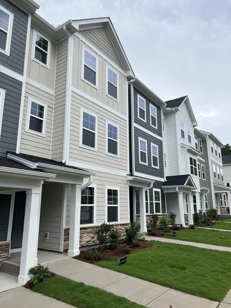 a front view of a residential apartment building with a yard