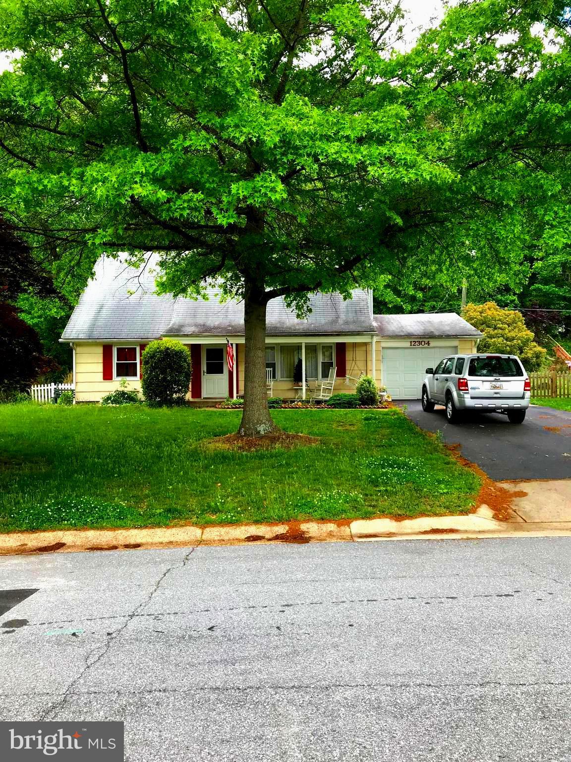 a view of house that has a yard