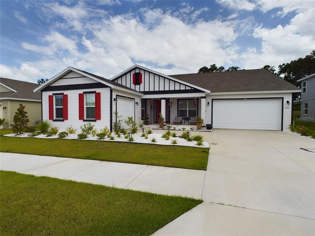 a front view of house with yard and green space