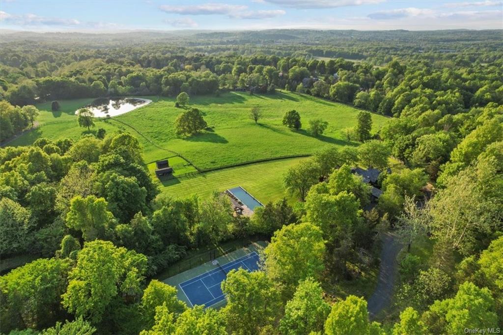 Tennis court, pool, entertaining pavilion and one of two ponds highlighted on the property. Subdivision possible; 2 acre zoning (RR) applies