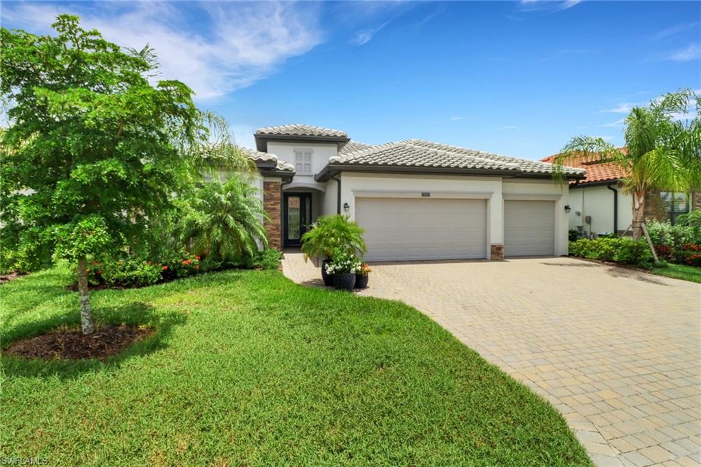 a front view of a house with a garden and plants