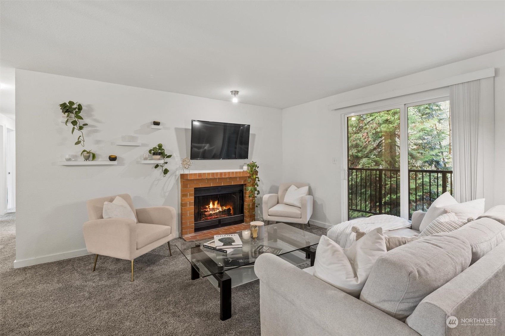 a living room with furniture a fireplace and a flat screen tv