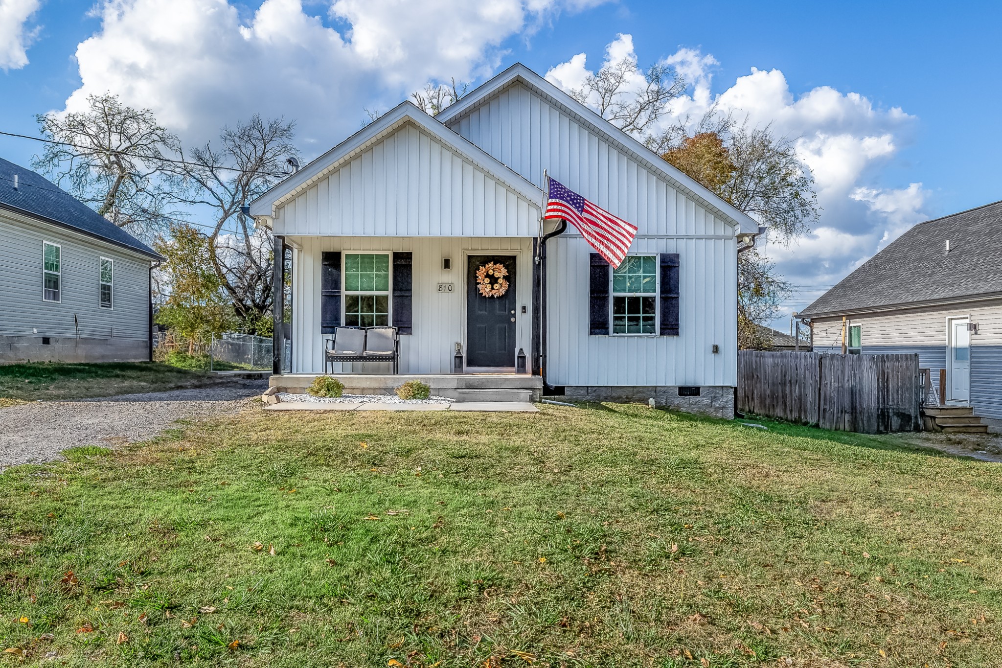 a view of a house with backyard and porch