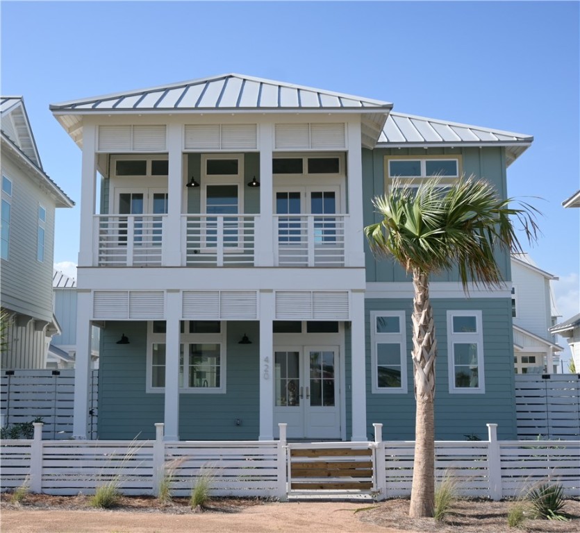 a front view of a house with plants