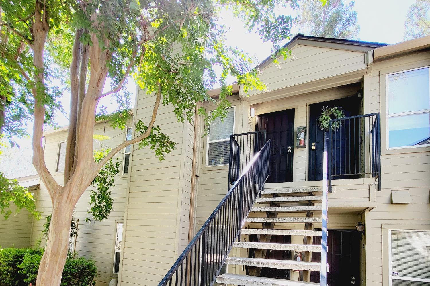 front view of a house with a tree