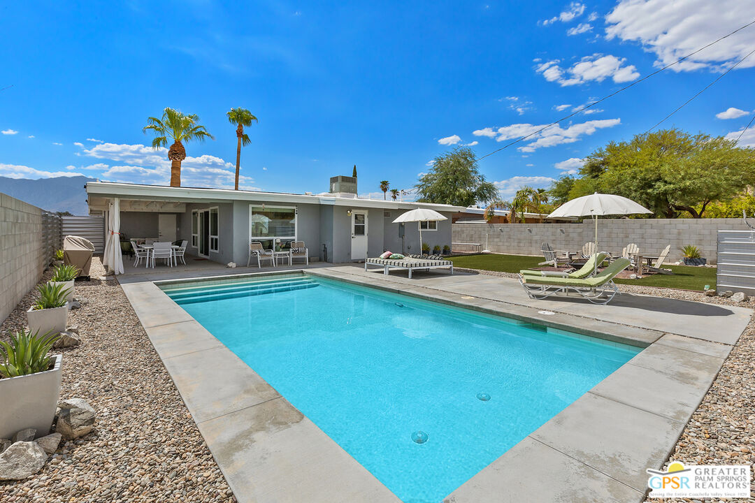 a view of a swimming pool with outdoor seating