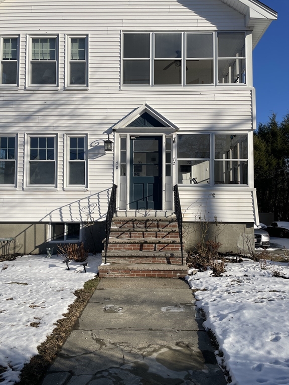 a front view of a house with a yard and balcony