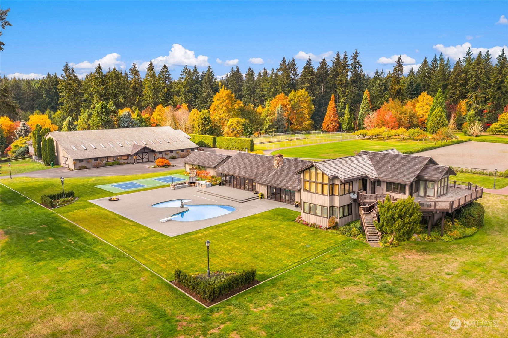 a view of a swimming pool with outdoor seating and a yard