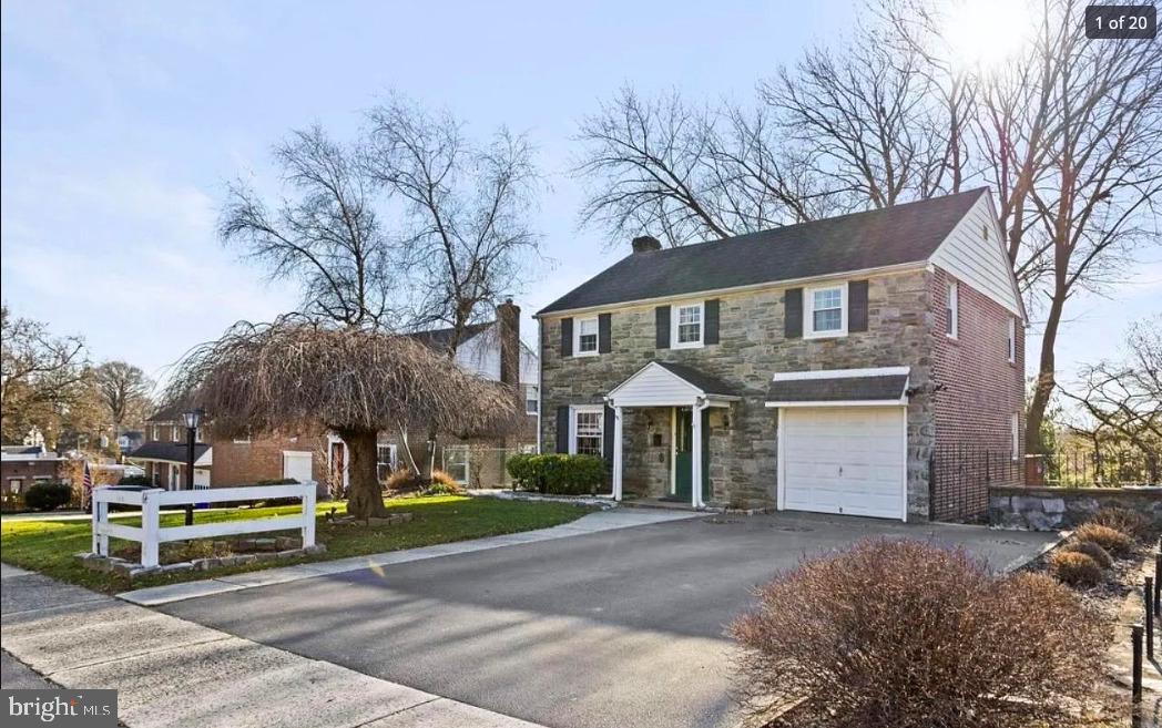 a front view of house with yard and trees around