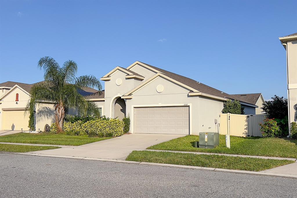 a front view of a house with a yard and garage