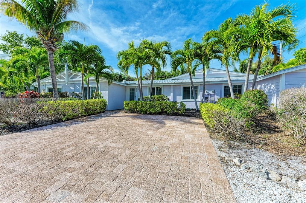 a house with palm tree in front of it