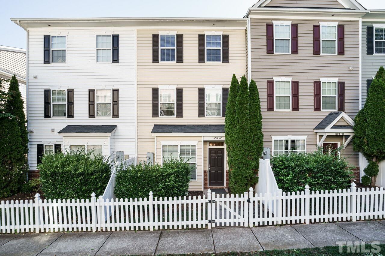 a front view of a house with iron fence