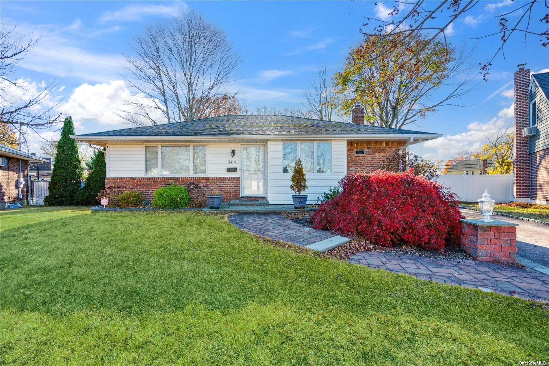 a front view of house with yard and outdoor seating