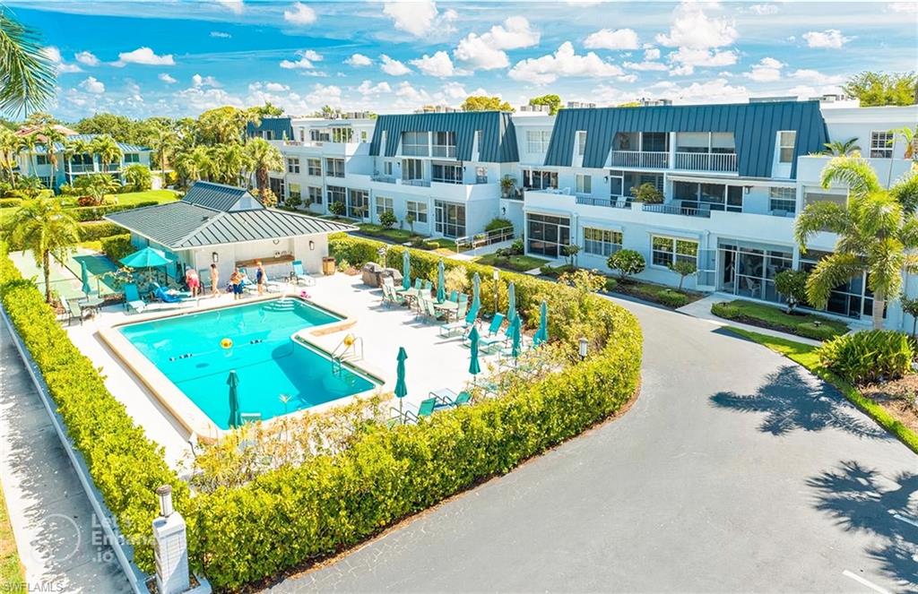 a view of a swimming pool with an outdoor seating and yard view