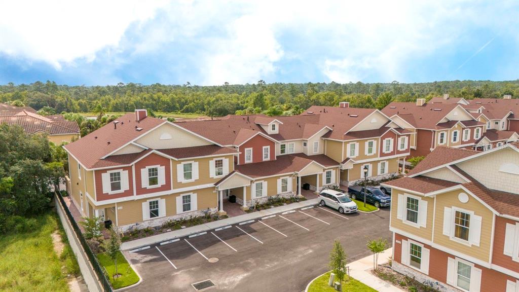 an aerial view of a residential apartment building with a yard