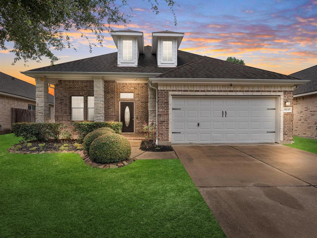 Pretty brick home has a large covered front porch