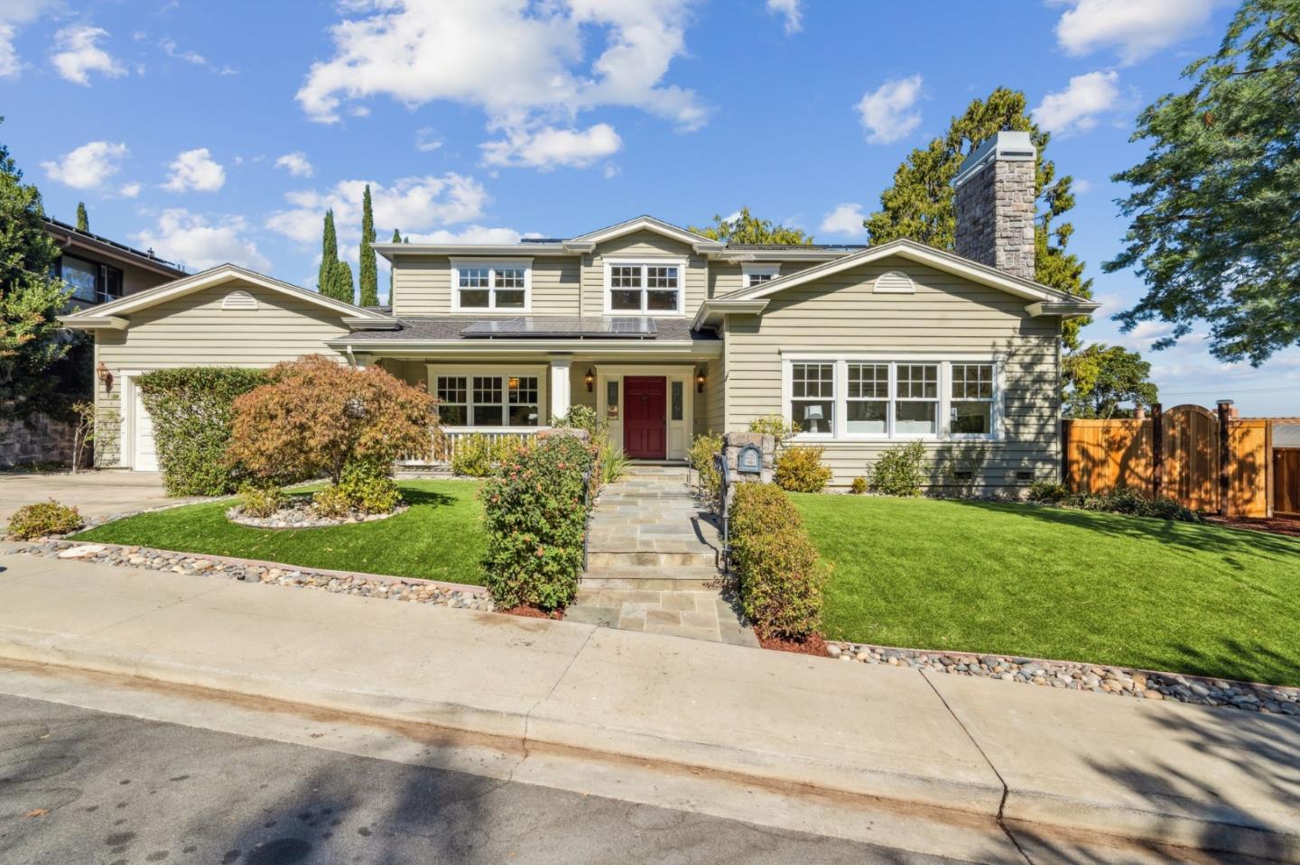 a front view of a house with a garden and plants