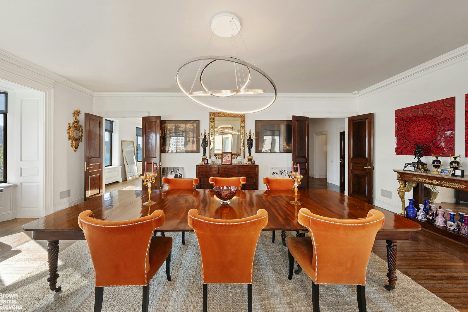 a dining room with furniture a window and wooden floor