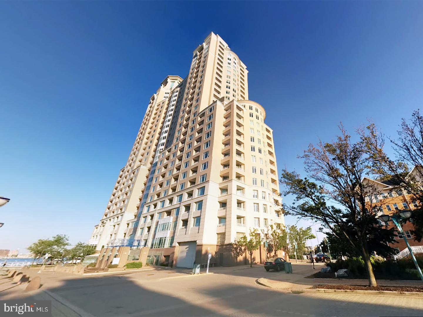 a view of a tall building next to a road