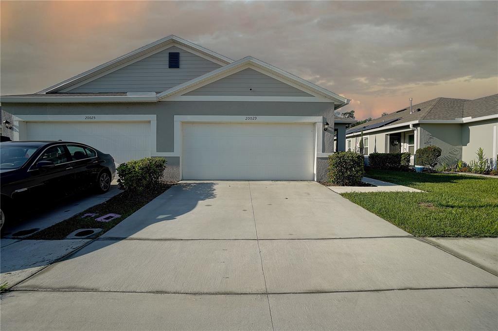 a front view of a house with garage