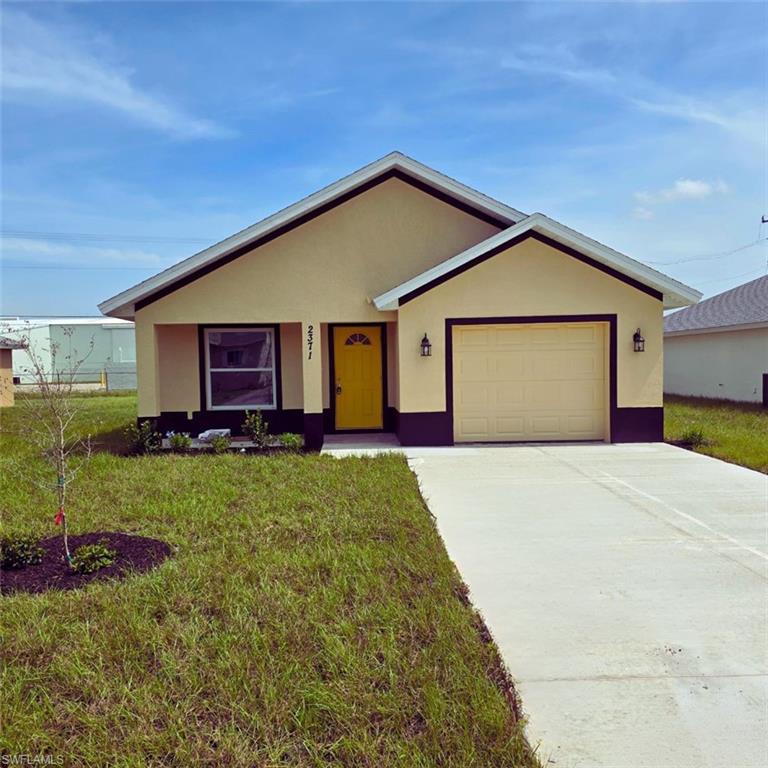 a front view of a house with a garden and yard