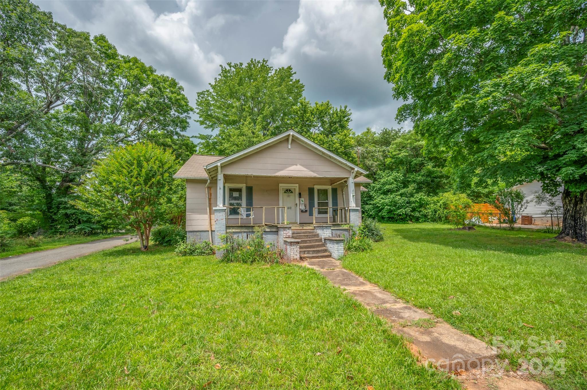 a front view of house with yard and green space