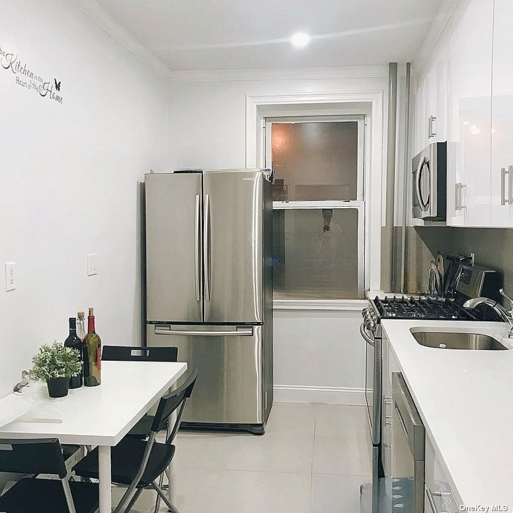 a kitchen with a refrigerator and a stove top oven