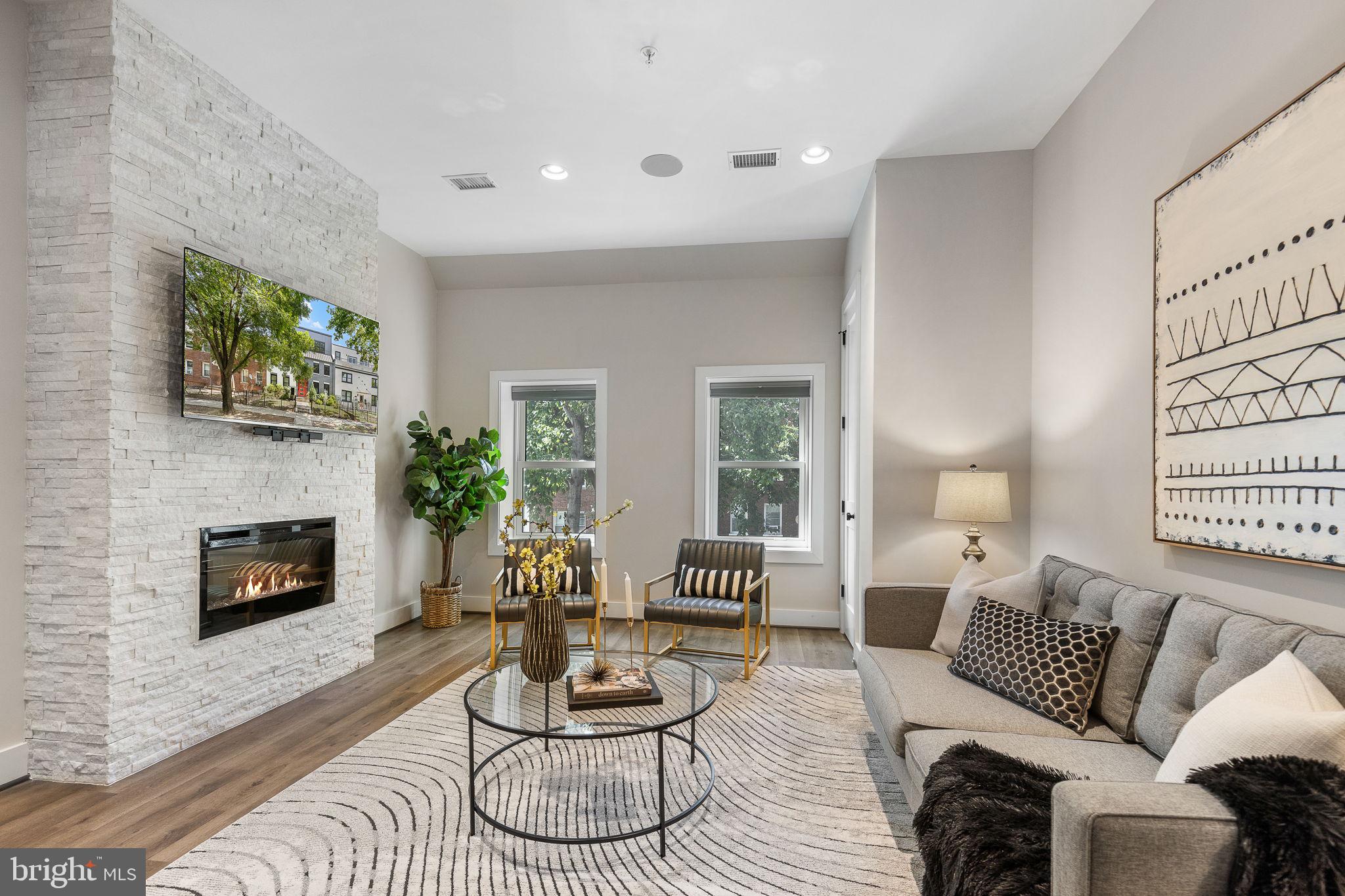 a living room with furniture and a fireplace