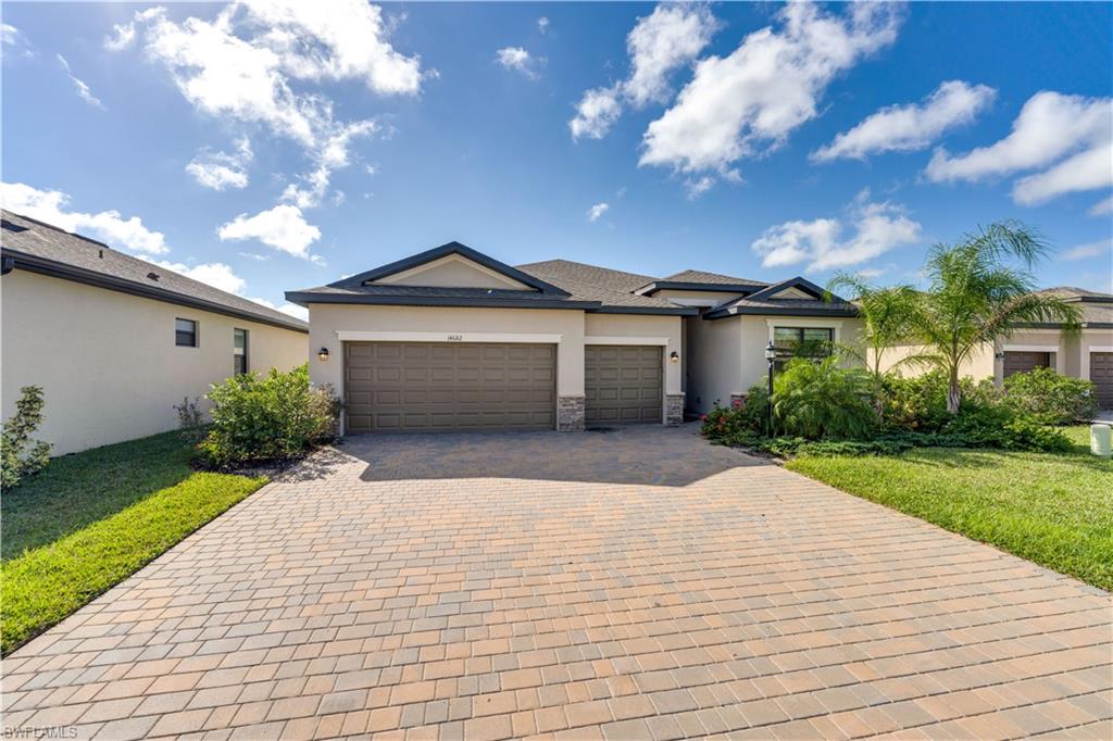 View of front of property with a garage and a front yard