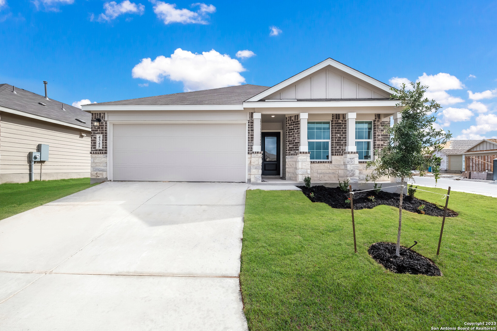 a front view of a house with a yard and entertaining space