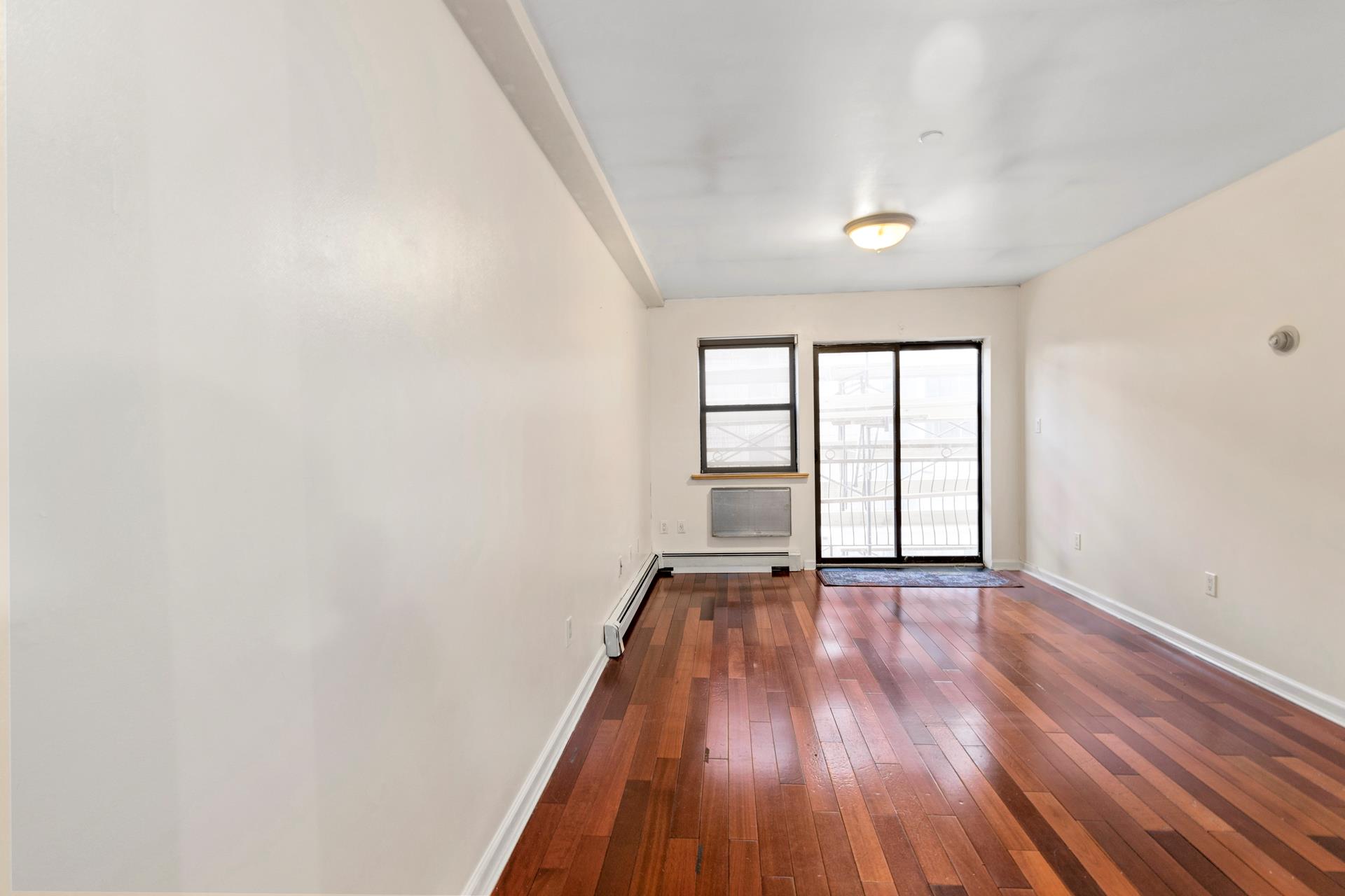 wooden floor in an empty room with a window