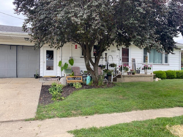 a house view with a sitting space and garden