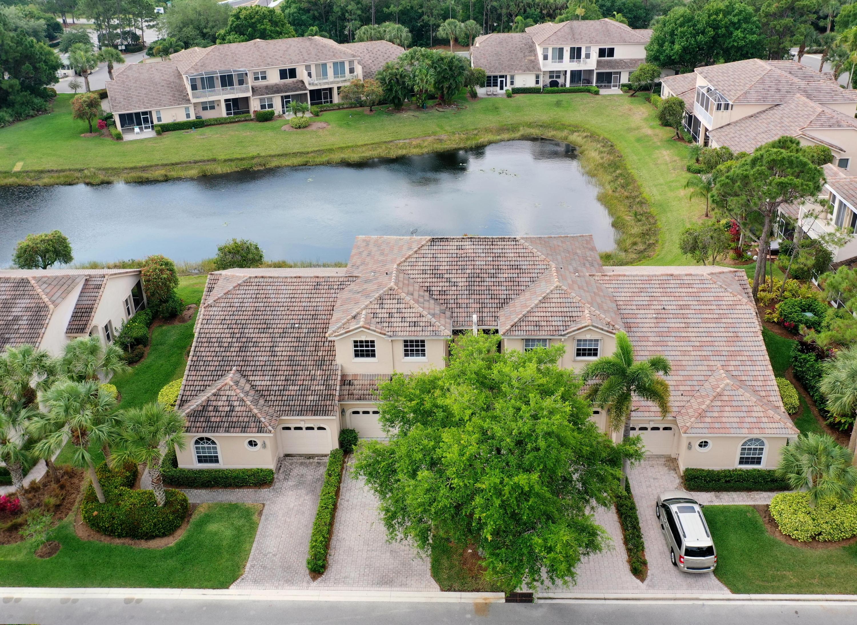 an aerial view of a house with garden space and lake view