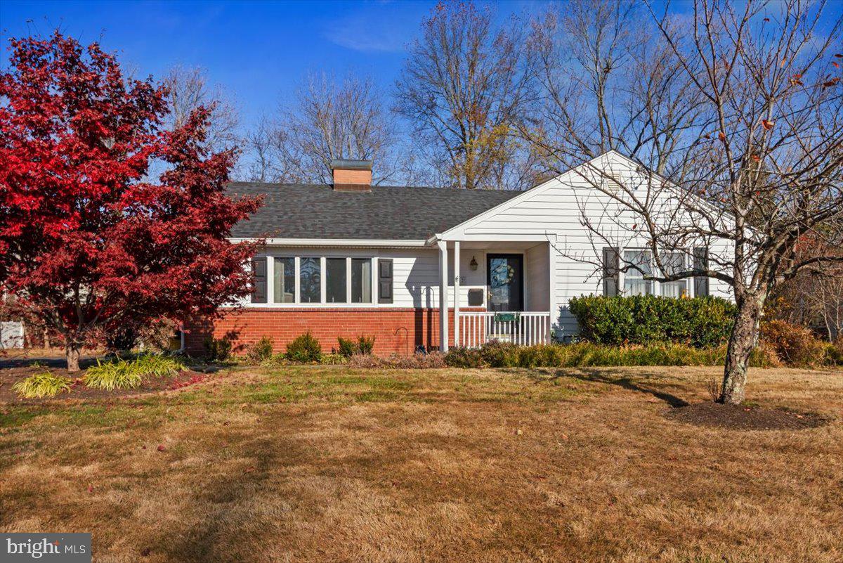 a view of house with a yard