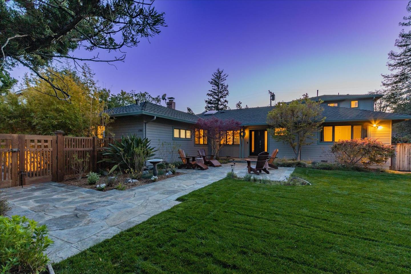 a view of a house with a backyard porch and sitting area