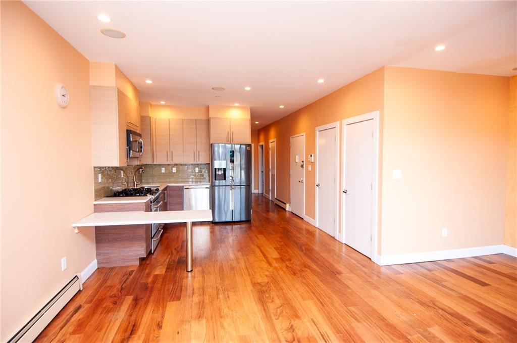 a view of a kitchen with wooden floor