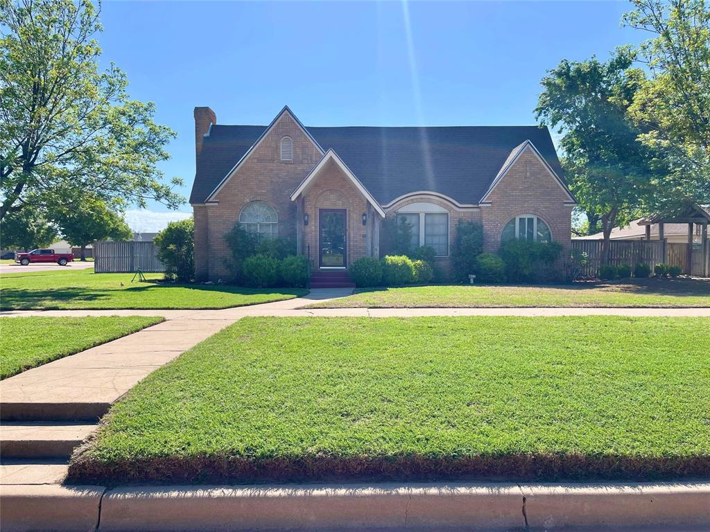 a front view of house with yard and green space