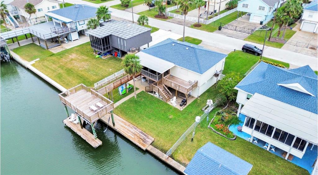 an aerial view of a house with a garden and swimming pool