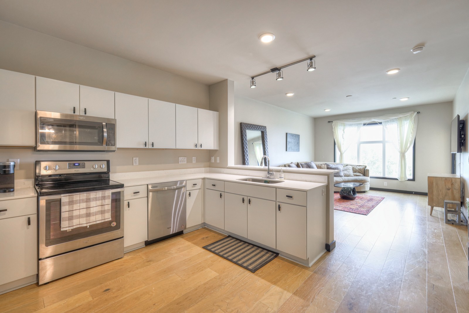 a kitchen with a sink stove and cabinets